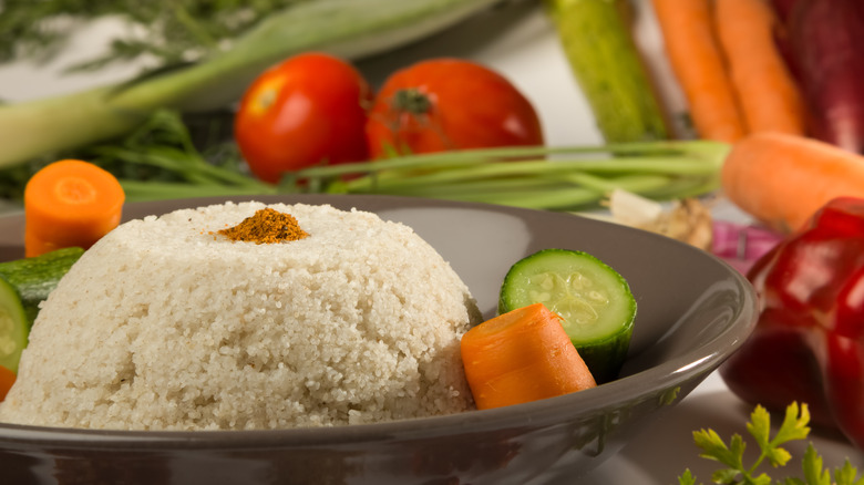 cooked fonio on a plate with veggies