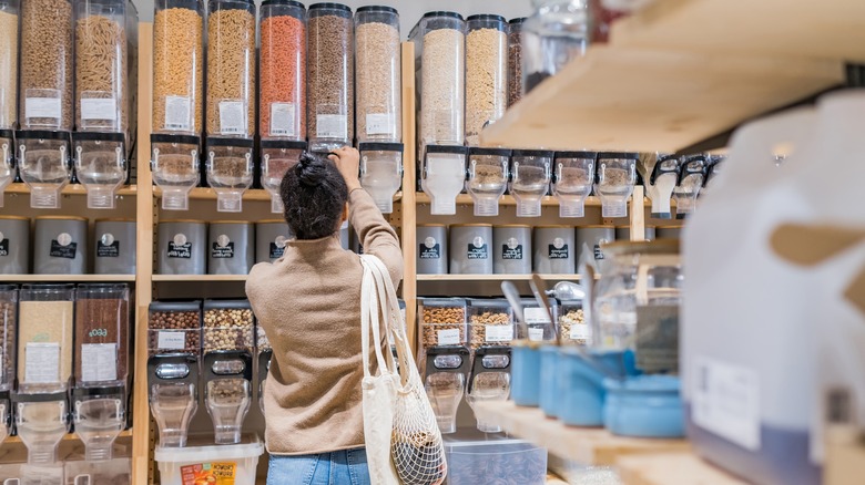 woman buying grains in bulk