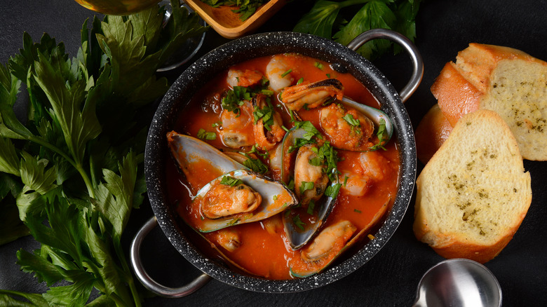 A pot of bouillabaisse and some bread