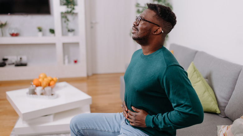 A man holding his stomach in pain