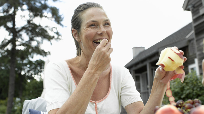 A woman eating an apple