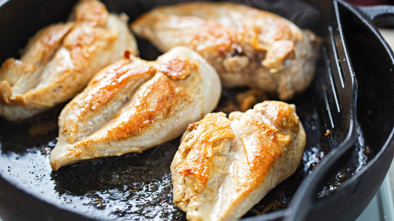 Chicken breasts cooking in a pan