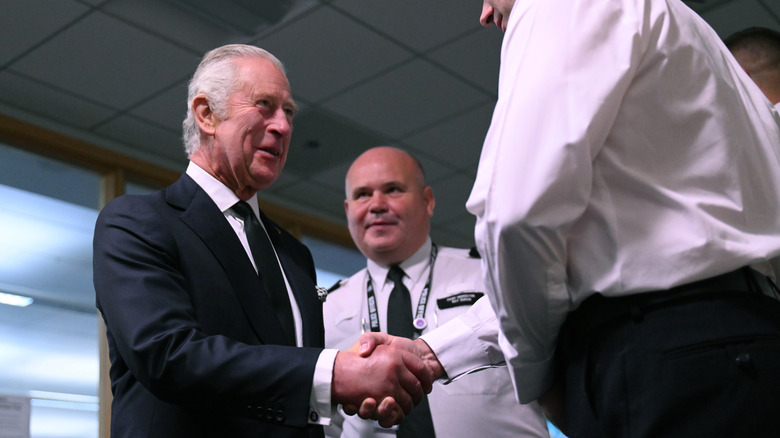 King Charles III shaking hands