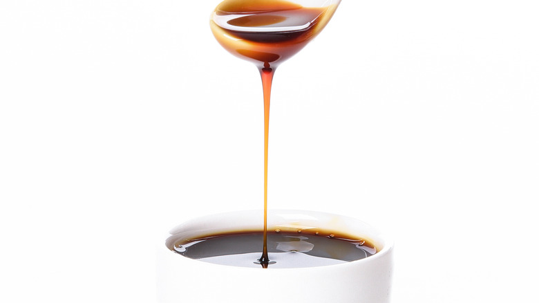 Molasses dripping on white background