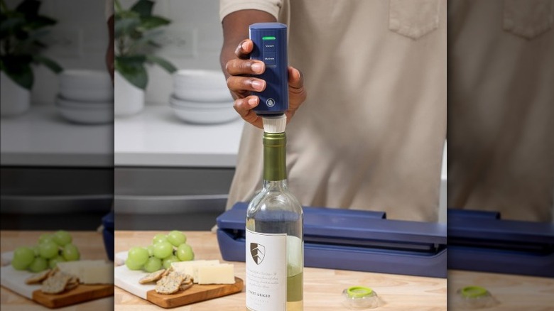 Food Saver hand-held device vacuum sealing a bottle of wine