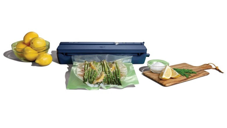 FoodSaver device vacuum sealing lemons and asparagus