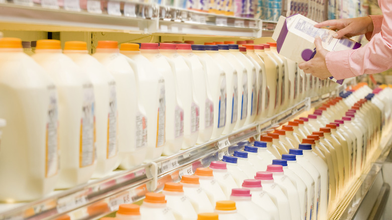 hand holding a carton of milk