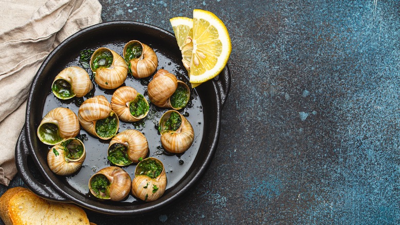 escargot in pan with lemon