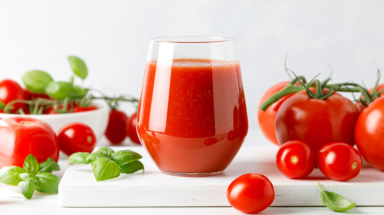 Glass of tomato juice with tomatoes