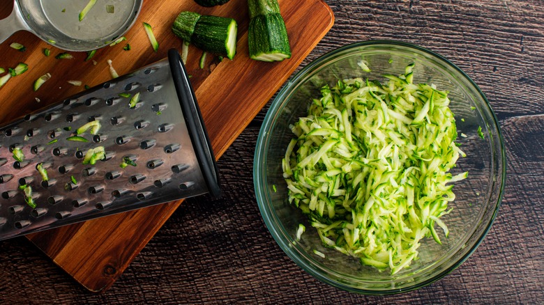 bowl of grated zucchini and box grater