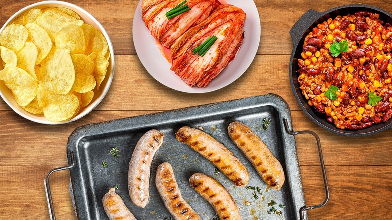 bratwursts with toppings on table