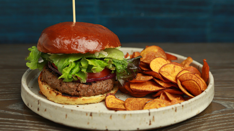 Beyond burger with chips on plate