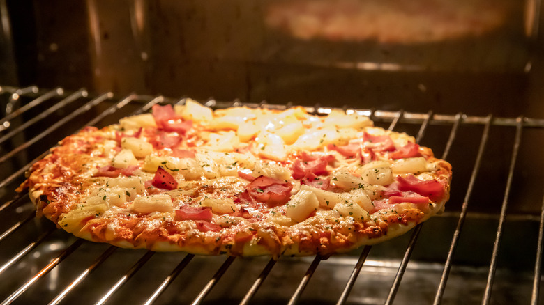 frozen pizza cooking in oven