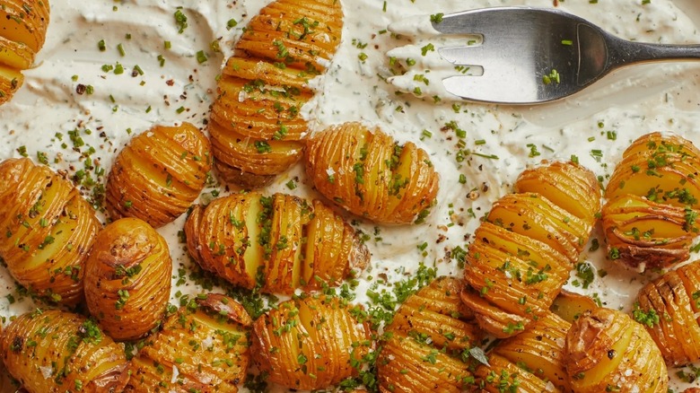 Mini Hasselback potatoes on sour cream and chives