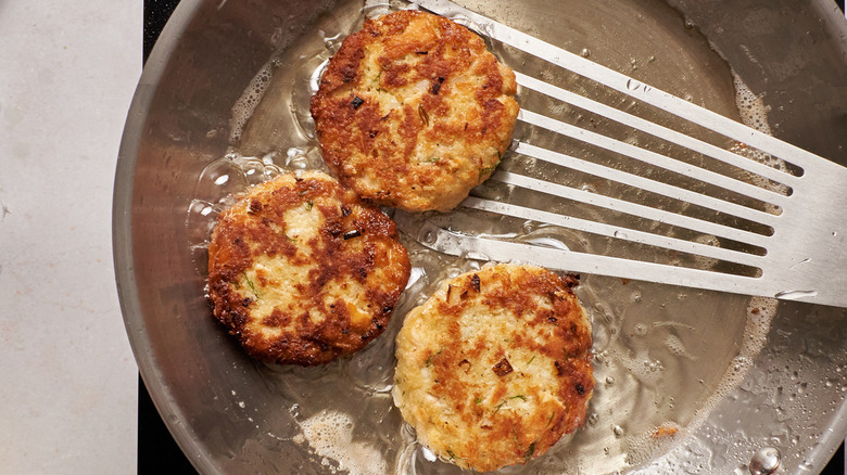 Tuna patties in frying pan 