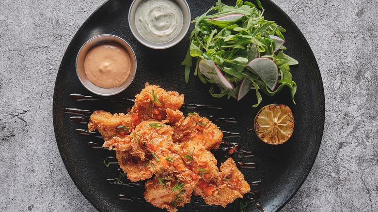 coated fried chicken with dips