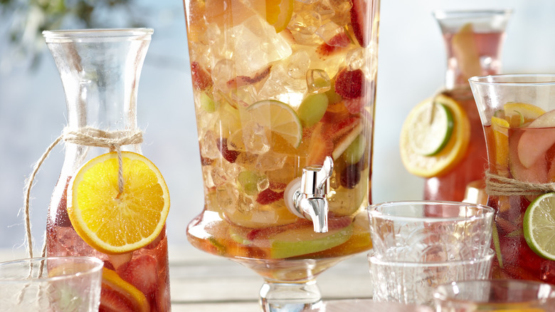 Several decanters filled with sangria and colorful fruit