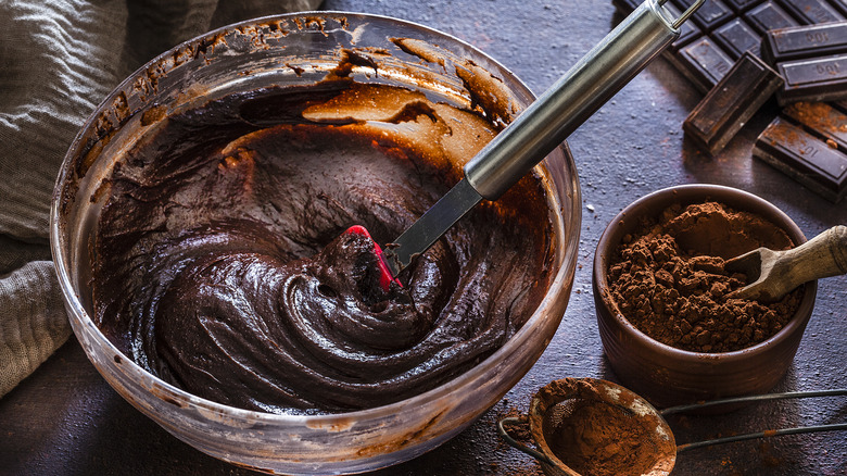 bowl of brownie batter and cocoa powder