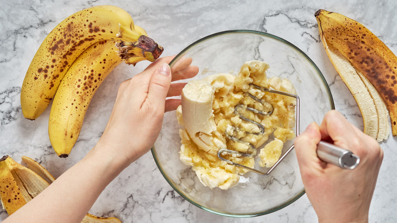 mashing bananas in a bowl