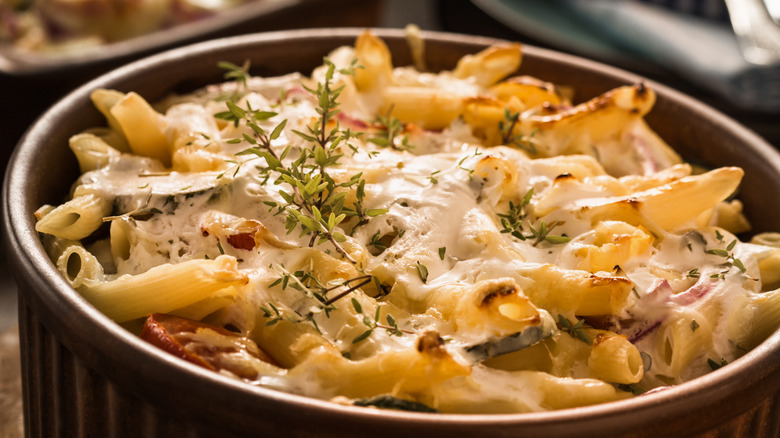 baked pasta dish garnished with fresh herbs