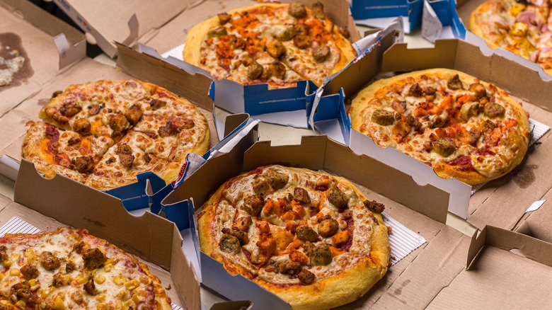 Several Domino's pizzas in open boxes