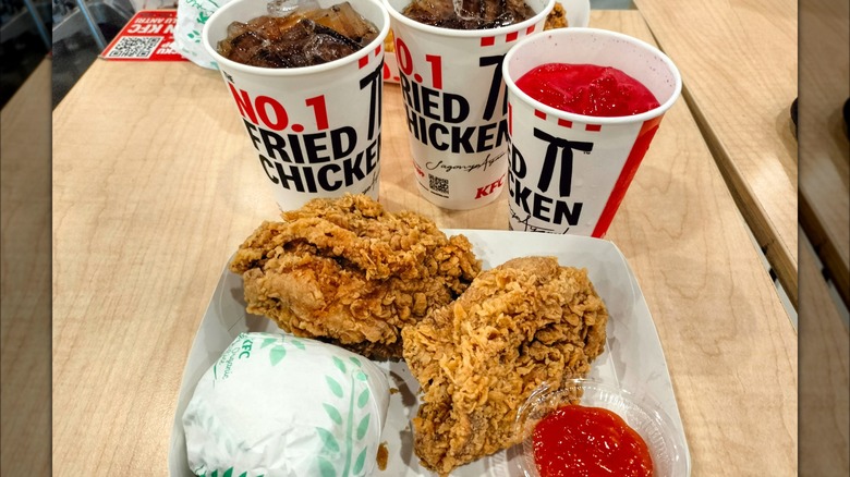 KFC fried chicken pieces, sandwich, and drinks