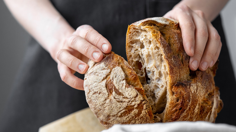 Woman holds loaf of bread