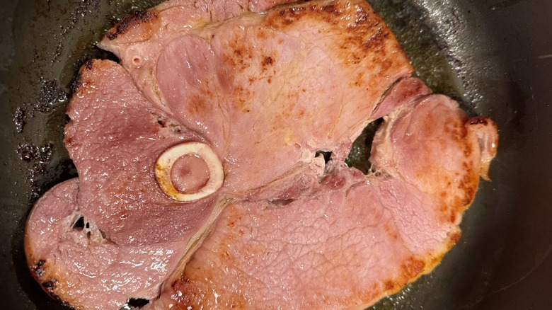 Ham steak cooking in pan