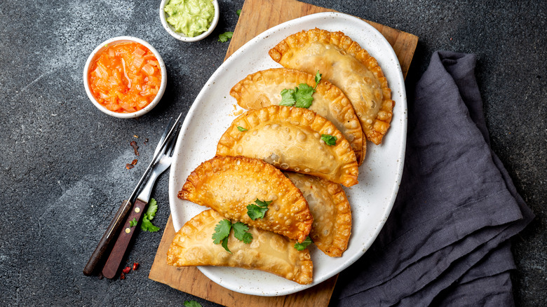 Empanadas on white plate with napkin