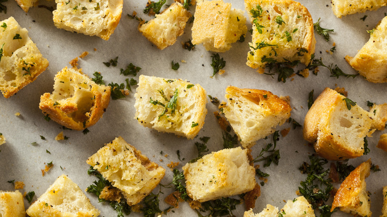 croutons with herbs on a baking pan