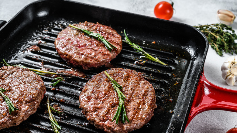 Burgers cooking in pan