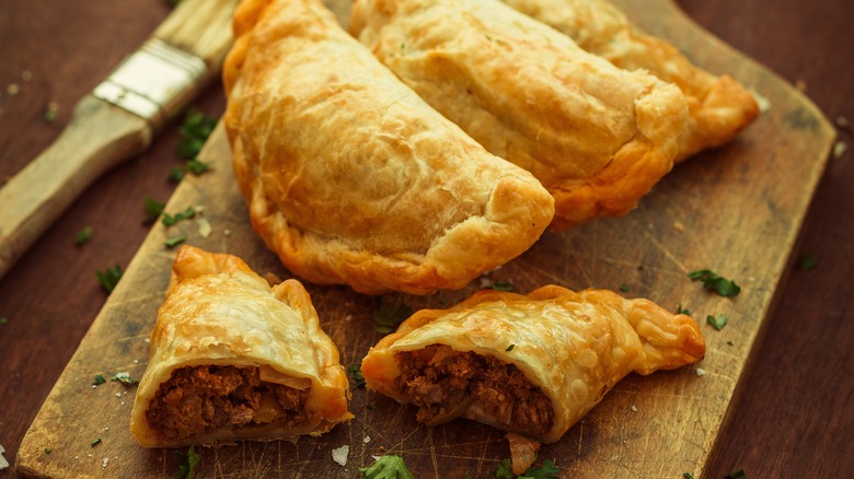 Empanadas on cutting board 