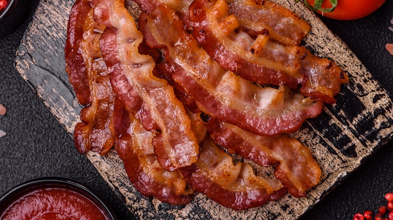 Fresh bacon on chopping board.