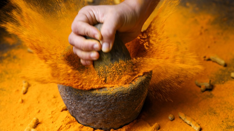 Spice flying from mortar and pestle