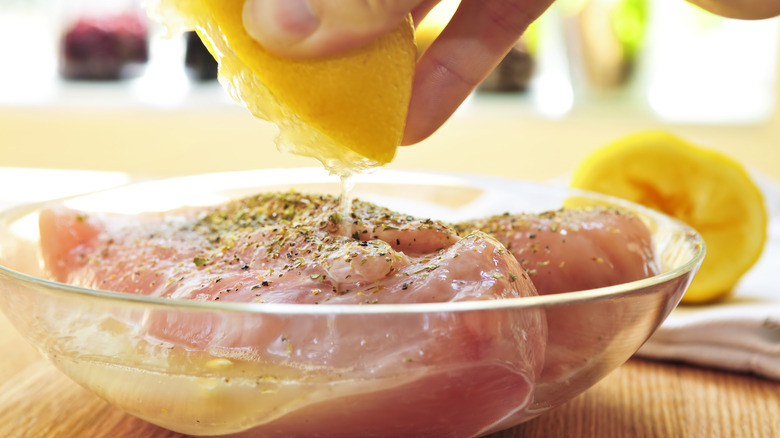 Chicken marinating in lemon juice