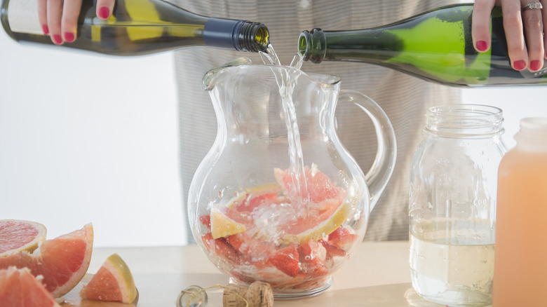 woman pouring wine into sangria 