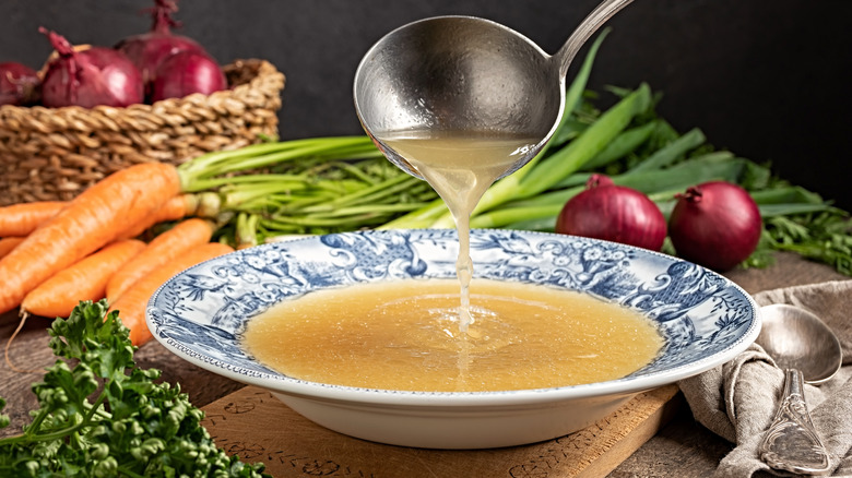 Bone broth ladled into a bowl 