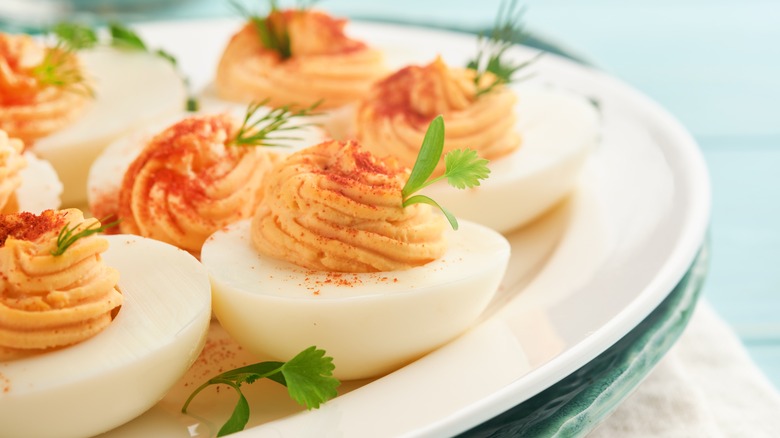 garnished deviled eggs on a platter