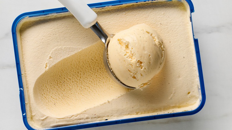 scooper in vanilla ice cream