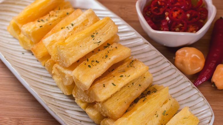 yucca fries with sliced red peppers on the side