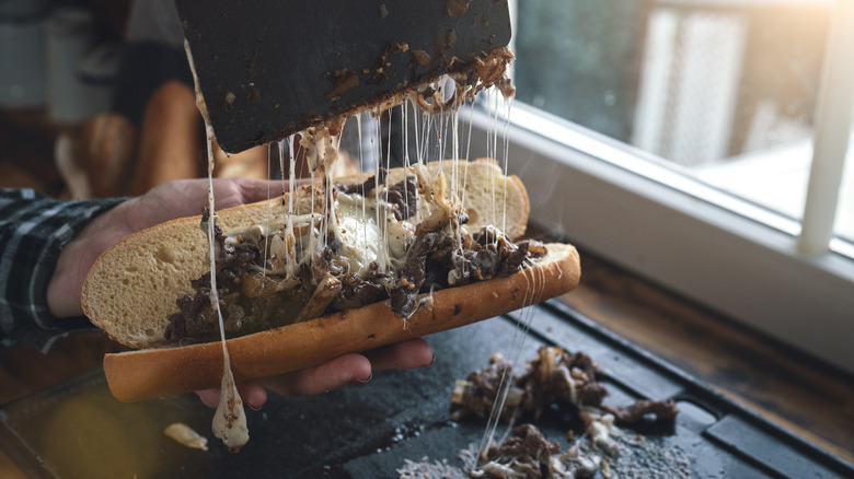 Philly cheesesteak being prepared