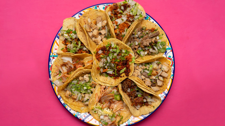 tacos with different fillings on a colorful plate