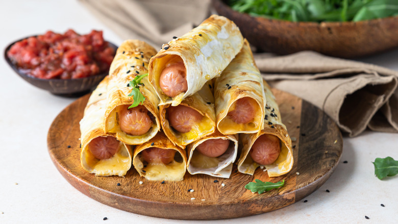 Hot dogs wrapped in tortillas with cheese.