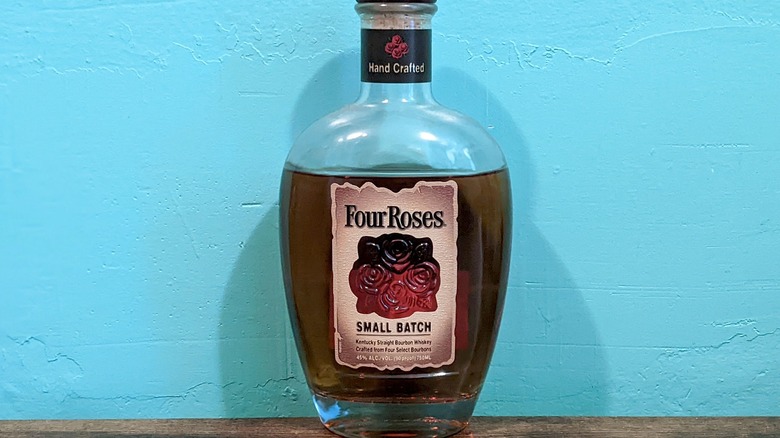 Four Roses Small Batch bourbon bottle on wood table