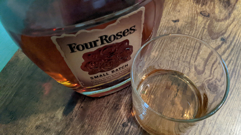 Top-down bird's eye view of Four Roses Small Batch bourbon bottle and glass of whiskey
