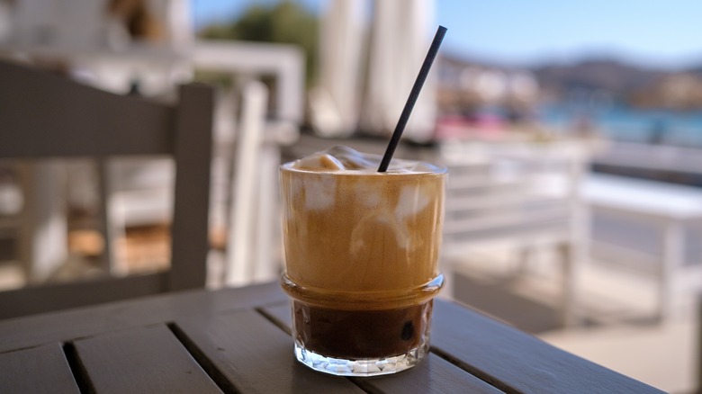 Freddo cappuccino on wood table outdoors