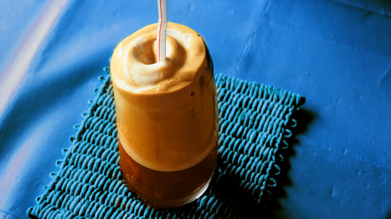 Foamy Greek frappé on blue background.