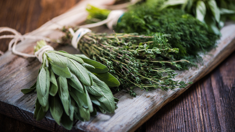 Herb bundles on wooden board