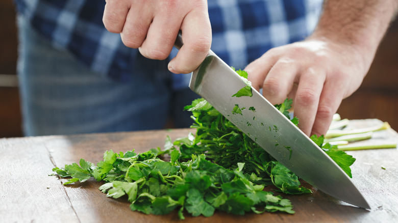 man chopping herbs