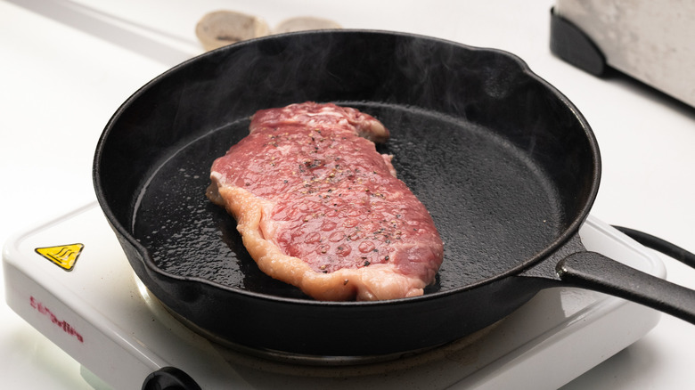 steak cooking in a pan